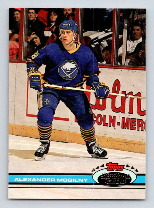 Hockey player in blue Buffalo Sabres uniform ready on ice for Topps Stadium Club card