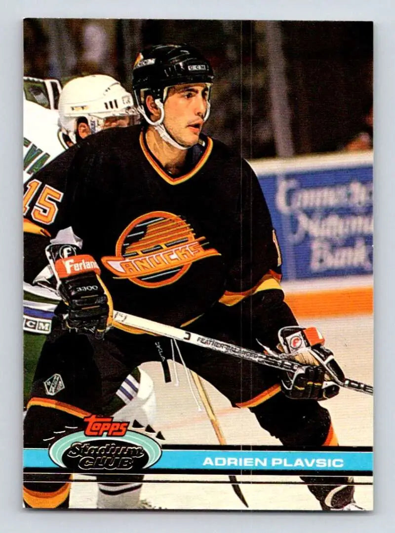 Hockey player in black Vancouver Canucks jersey, showcasing Adrien Plavsic Topps Stadium Club