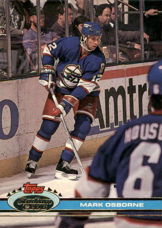 Hockey player in blue jersey skating during game on 1991-92 Topps Stadium Club card