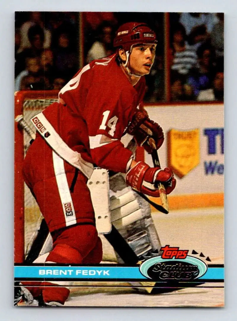 Hockey player in red Detroit Red Wings jersey #14 showcasing Brent Fedyk on ice