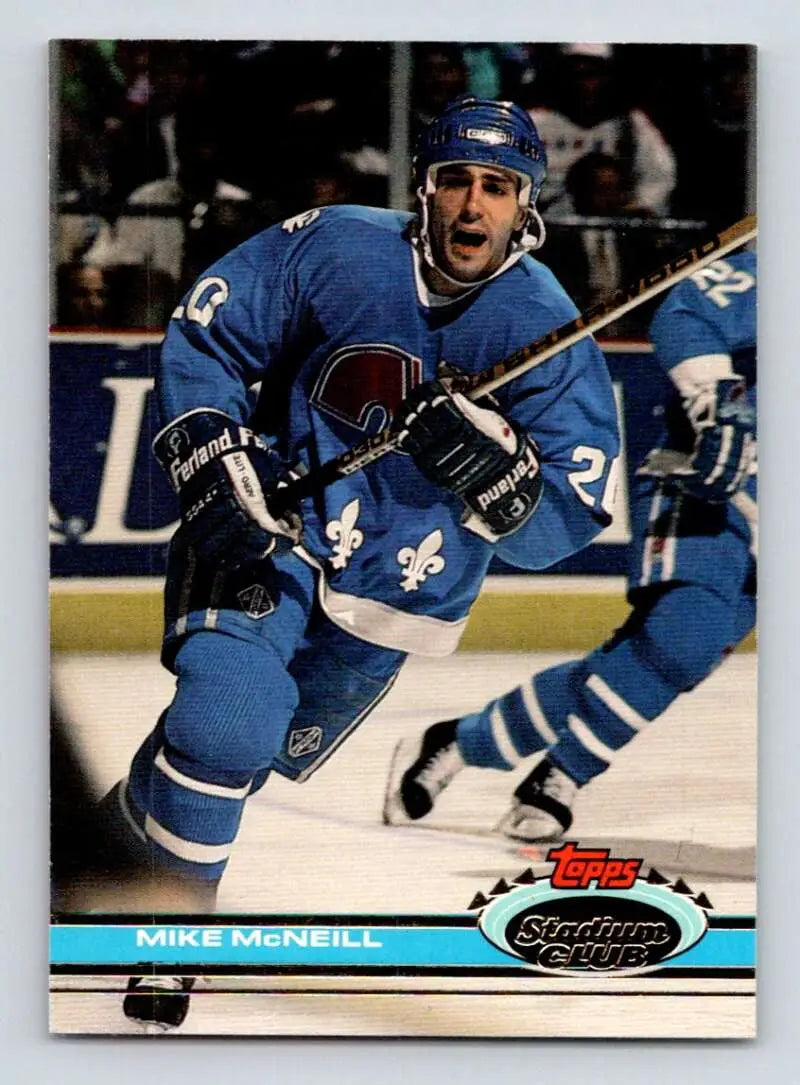 Hockey player in blue Quebec Nordiques jersey skating for Topps Stadium Club Mike McNeil card