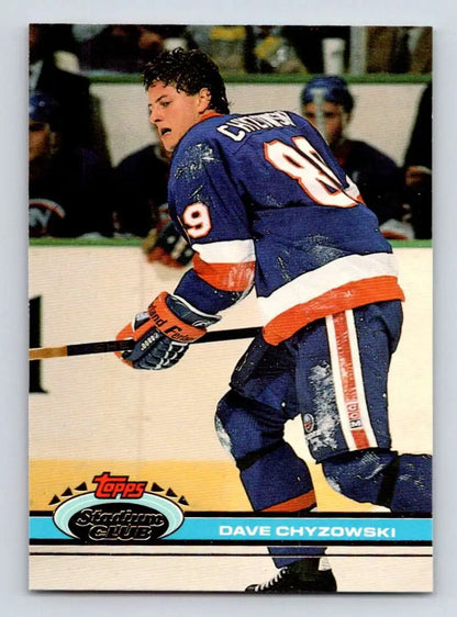 Hockey player in New York Islanders jersey skating, featured on Topps Stadium Club card