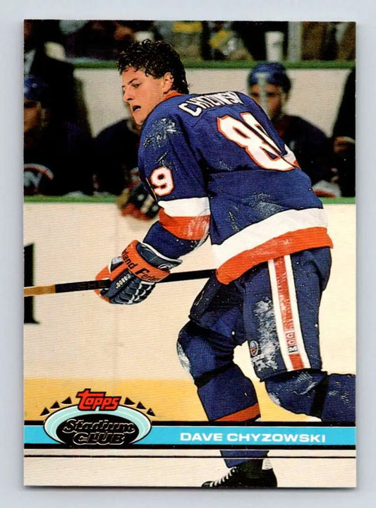 Hockey player in New York Islanders jersey skating, featured on Topps Stadium Club card