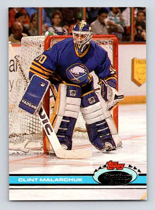 Hockey goalie in blue Buffalo Sabres jersey showcasing Clint Malarchuk Topps Stadium Club card