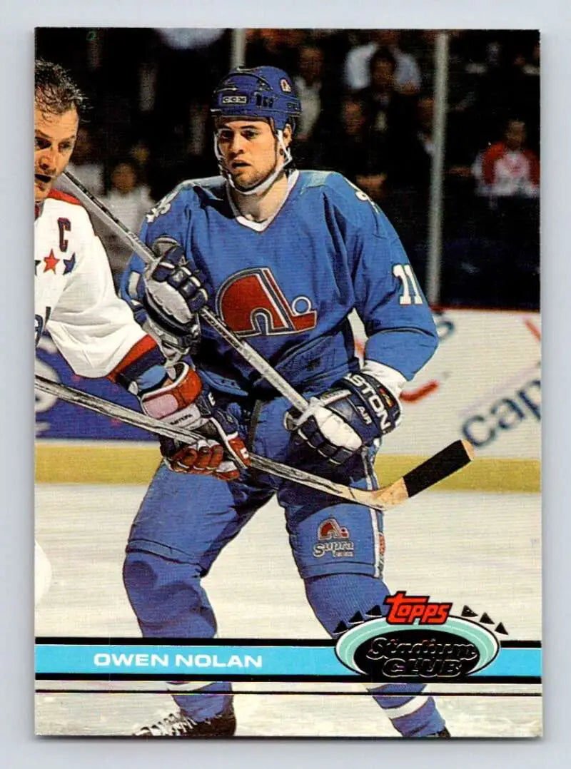 Hockey player in blue Quebec Nordiques jersey during gameplay on Topps Stadium Club card