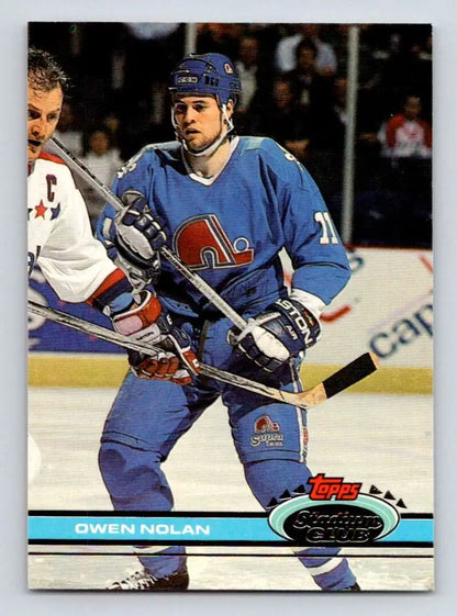 Hockey player in blue Quebec Nordiques jersey during gameplay on Topps Stadium Club card