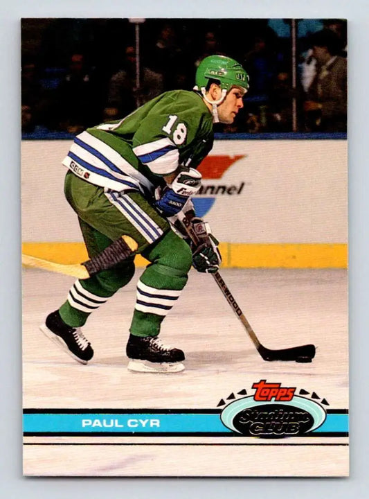 Hockey player in green and white jersey controlling puck, featuring Paul Cyr Hartford Whalers