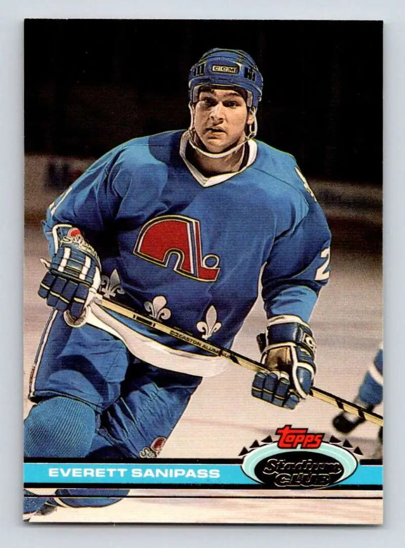 Hockey player in a blue Quebec Nordiques jersey with stick for Topps Stadium Club card