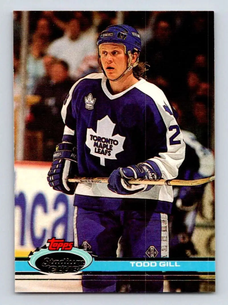 Hockey player in Toronto Maple Leafs jersey and blue helmet, Todd Gill card collectible