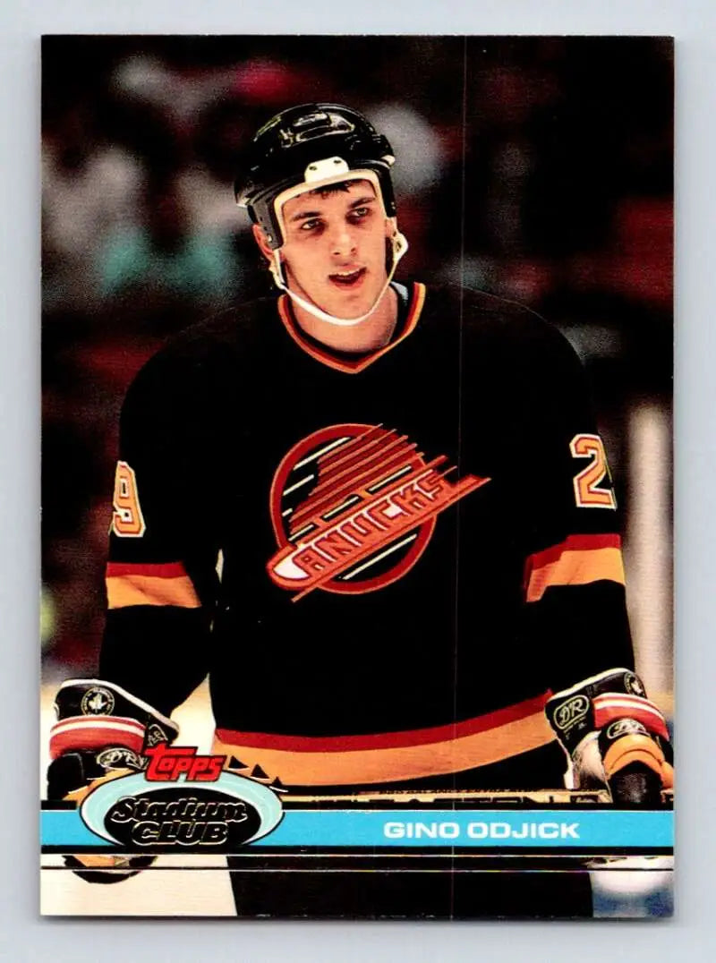 Hockey player in black Vancouver Canucks jersey, 1991-92 Topps Stadium Club Gino Odjick