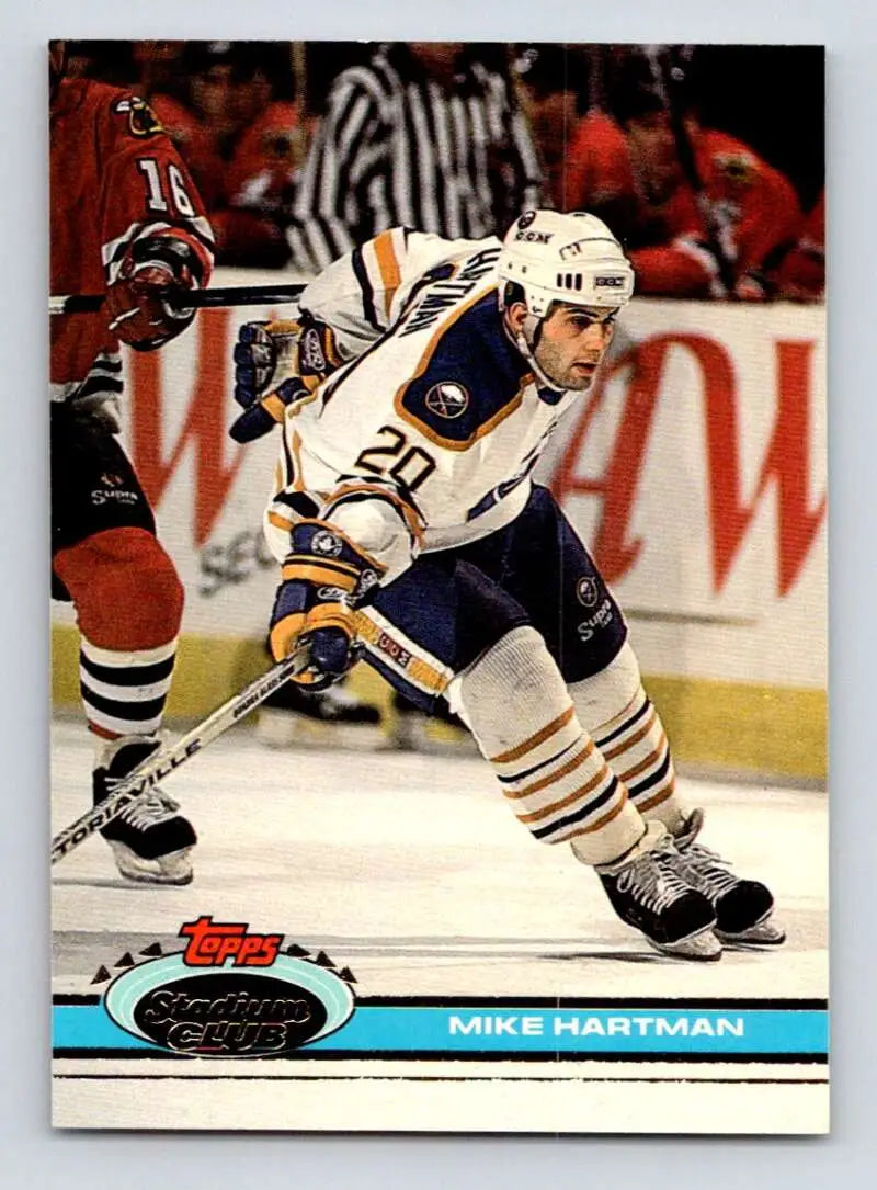 Hockey player in white and blue jersey skating, featuring Mike Hartman, Buffalo Sabres