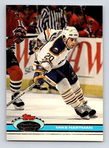 Hockey player in white and blue jersey skating, featuring Mike Hartman, Buffalo Sabres