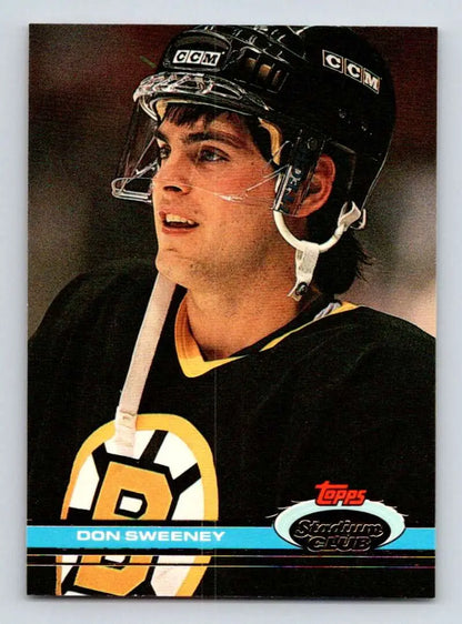 Hockey player in a Boston Bruins jersey and helmet on a Don Sweeney hockey card