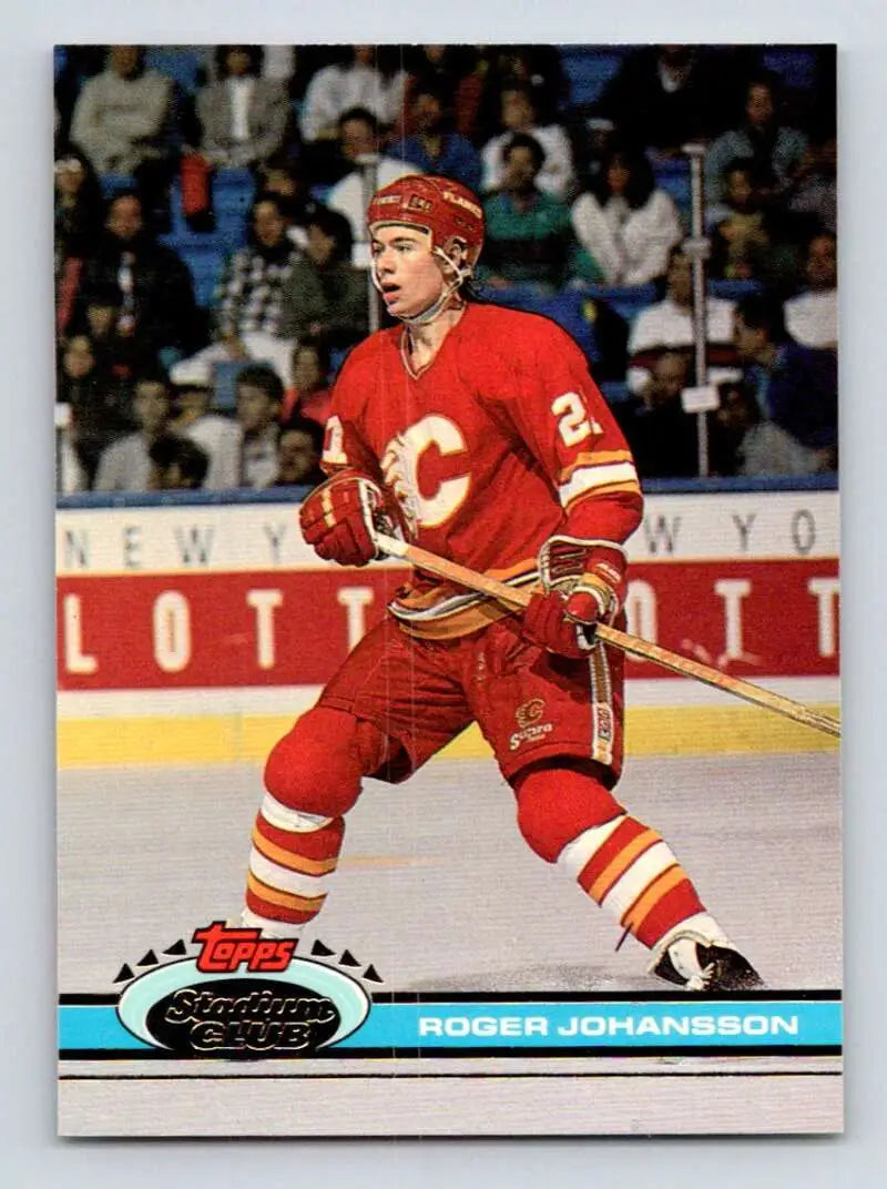 A hockey player in a red Calgary Flames jersey skating on ice for Topps Stadium Club