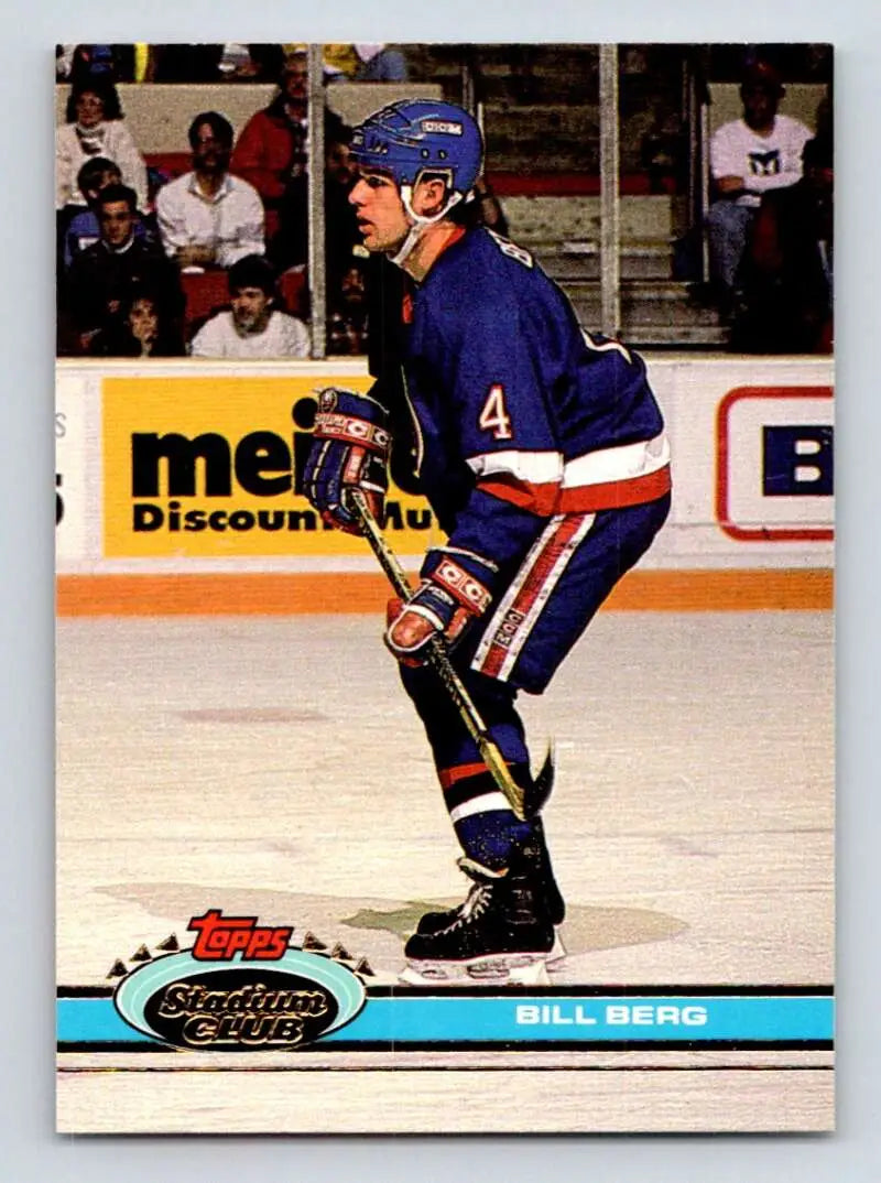 Hockey player in blue jersey number 4 skating for New York Islanders Topps Stadium Club card