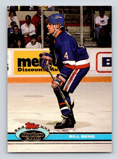 Hockey player in blue jersey number 4 skating for New York Islanders Topps Stadium Club card
