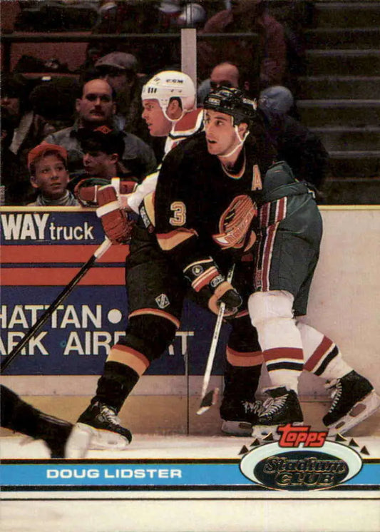Hockey trading card featuring Anaheim Mighty Ducks vs Vancouver Canucks game action
