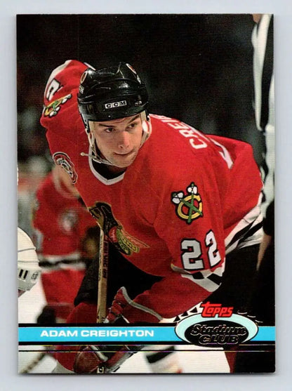 Hockey player in red Chicago Blackhawks jersey number 28 on Topps Stadium Club card