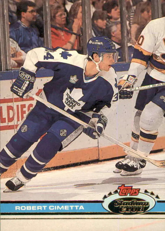 Toronto Maple Leafs player in blue and white uniform skating in a game action shot