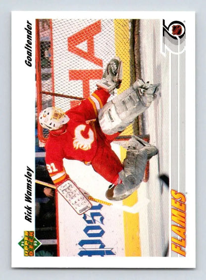 Hockey goalie Rick Wamsley in red Calgary Flames jersey making a save on Upper Deck card