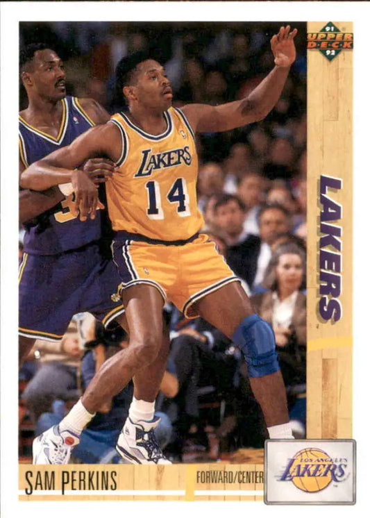 Basketball player in yellow Lakers jersey #14 reaching up in game action, Sam Perkins card