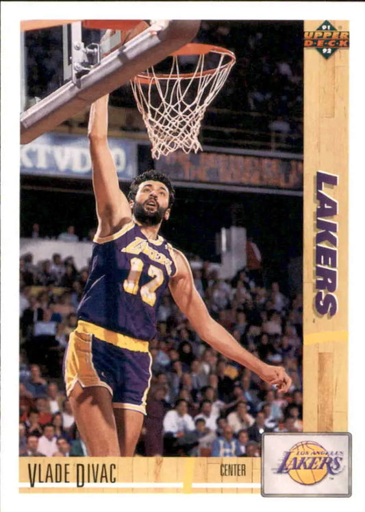 Vlade Divac dunking in purple and gold uniform on Los Angeles Lakers trading card