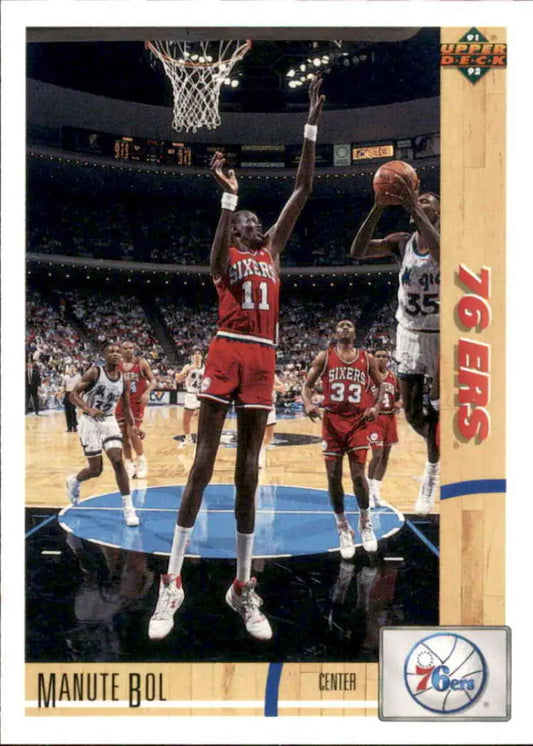 Basketball card of Manute Bol blocking a shot for the Philadelphia 76ers during a game