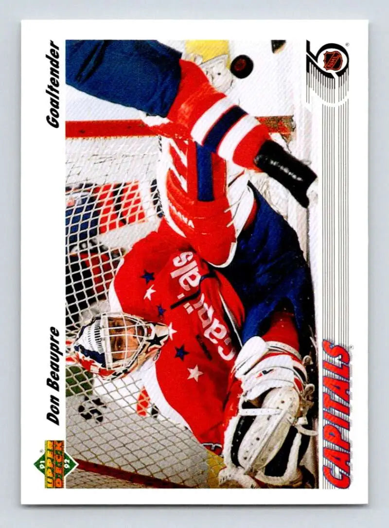 Hockey goalie Don Beaupre in red and blue uniform making a save for Washington Capitals