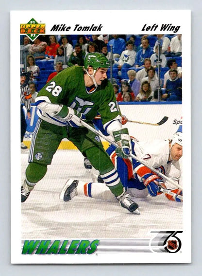 Hockey player in Hartford Whalers jersey skates past fallen opponent, Mike Tomlak card