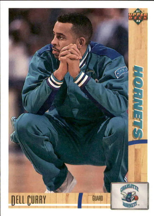 Dell Curry in teal Charlotte Hornets warmup suit with hands on face, showcasing passion