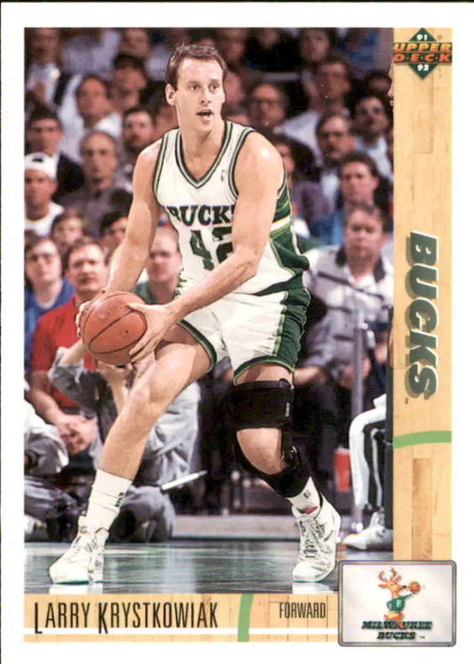Basketball player in Milwaukee Bucks uniform dribbling, featured on Larry Krystkowiak card