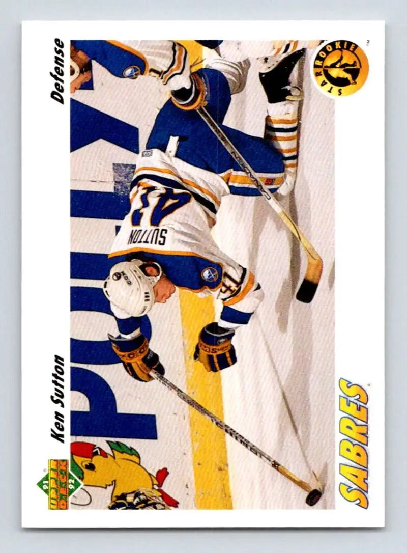 Hockey player diving in yellow and blue uniform on Ken Sutton Buffalo Sabres Hockey Card