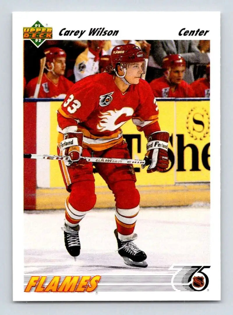 Hockey player in red Calgary Flames jersey showcasing Carey Wilson Upper Deck hockey card