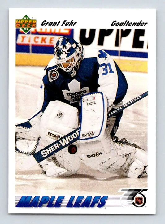 Hockey goalie Grant Fuhr in Toronto Maple Leafs uniform saves puck, featured on card