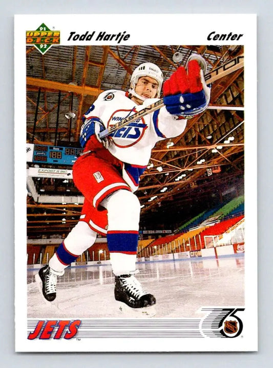 Hockey player in white Winnipeg Jets jersey leaping on ice for Todd Hartje rookie card