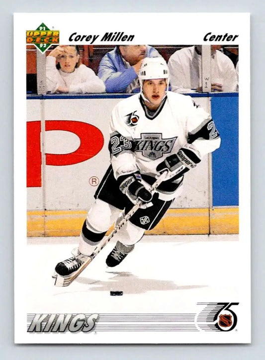 Hockey player in a white Los Angeles Kings jersey skating with a puck