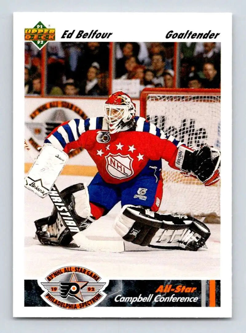 Hockey goalie in red, white, and blue jersey making a save, Chicago Blackhawks hockey