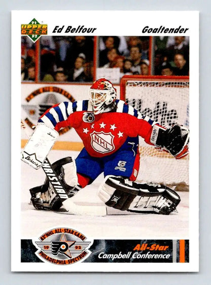 Hockey goalie in red, white, and blue jersey making a save, Chicago Blackhawks hockey