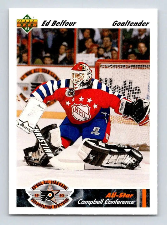 Hockey goalie in red, white, and blue jersey making a save, Chicago Blackhawks hockey