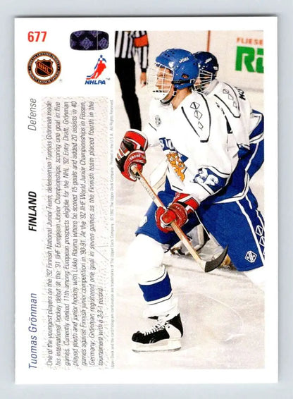 Tomas Gronman takes a shot in a blue and white uniform on the Upper Deck hockey card