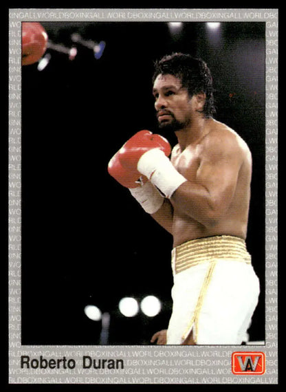 Roberto Duran in red gloves and gold-trimmed white shorts for boxing card display