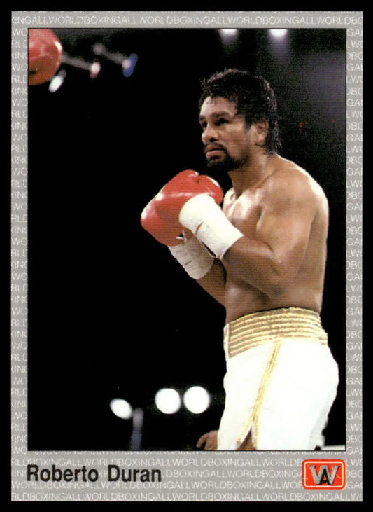 Roberto Duran in red gloves and gold-trimmed white shorts for boxing card display