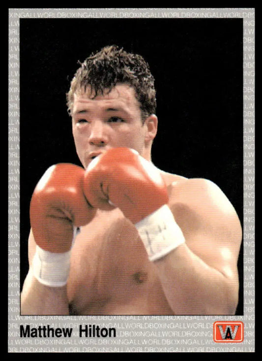 Matthew Hilton in a defensive stance with red gloves on a boxing card, showcasing boxing history