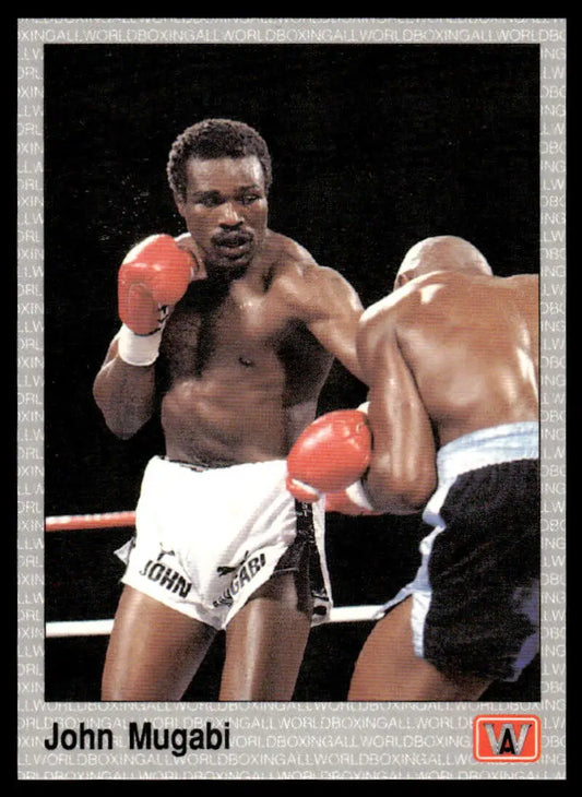 Two boxers in a match; featured in a John Mugabi NM-MT boxing card