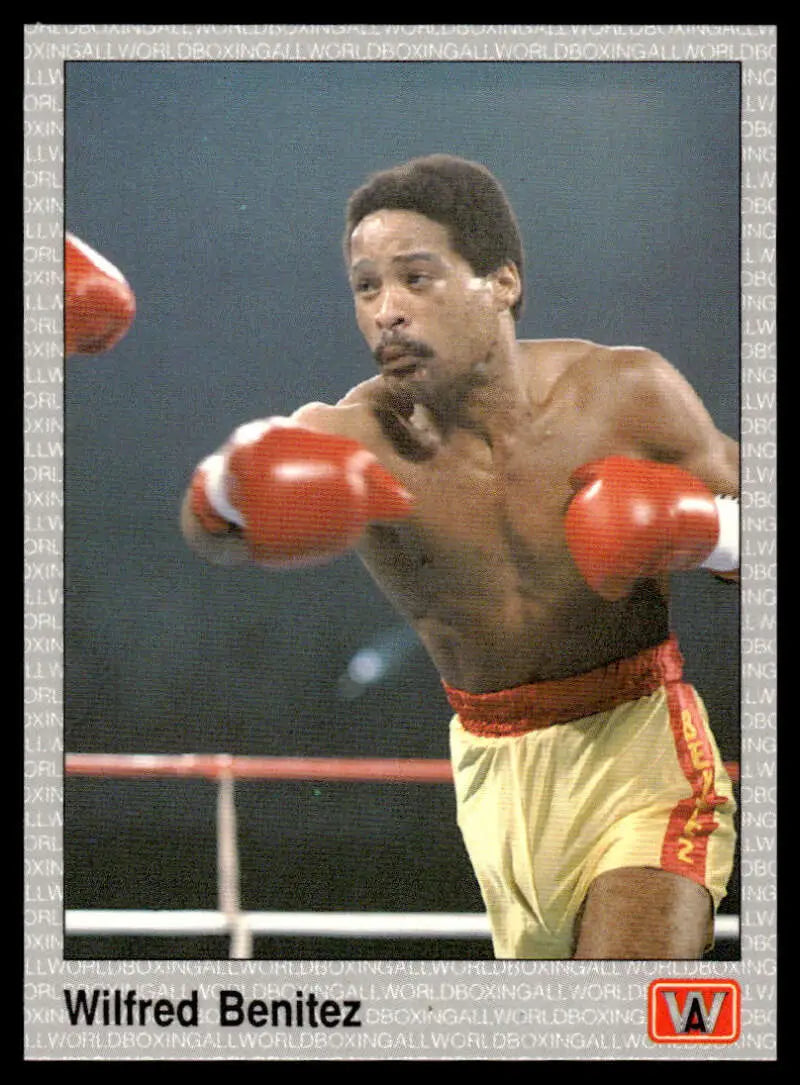 A boxer in yellow shorts throwing punches in red gloves for Wilfred Benitez boxing card