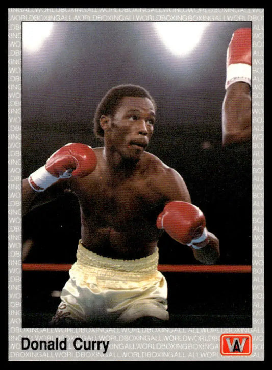 Boxer in white shorts and red gloves ready to fight, featured on Donald Curry NM-MT card