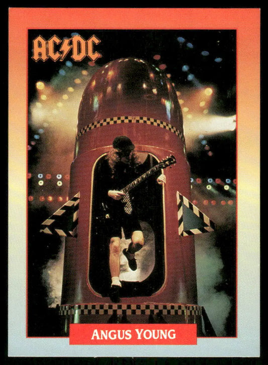 Musician playing guitar inside a red rocket-shaped stage prop on Brockum RockCards Angus Young