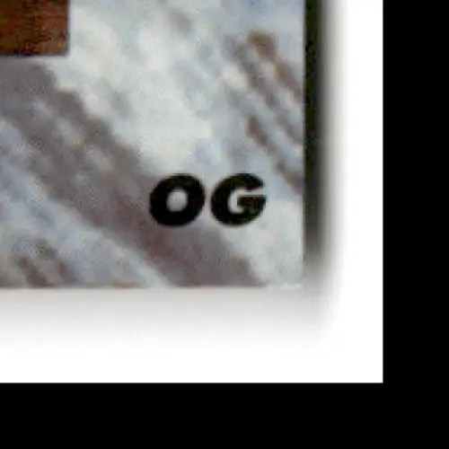 Rectangular sticker with OG printed on it for 1991 Classic Multi-Sport Kevin Lynch Charlotte Hornets