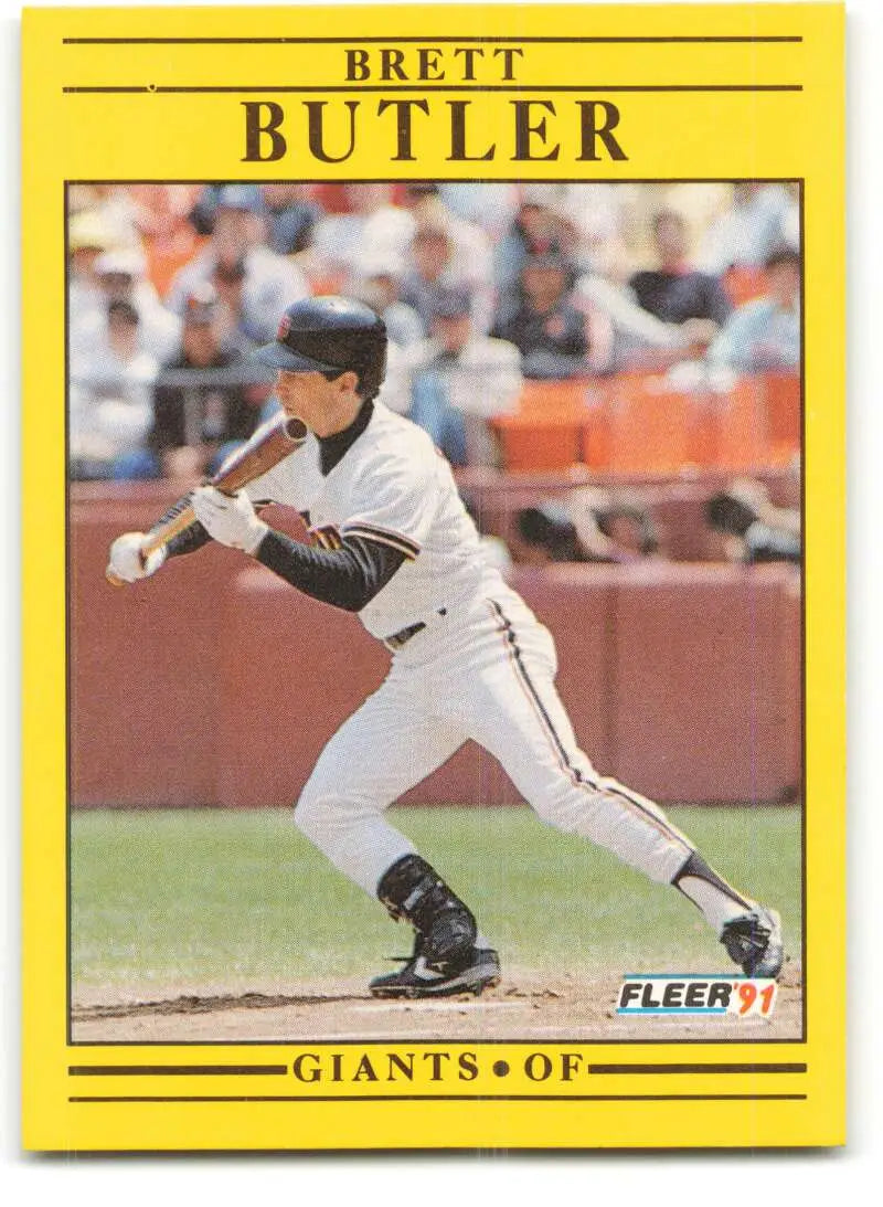 Yellow-bordered baseball card of Brett Butler, San Francisco Giants outfielder bunting