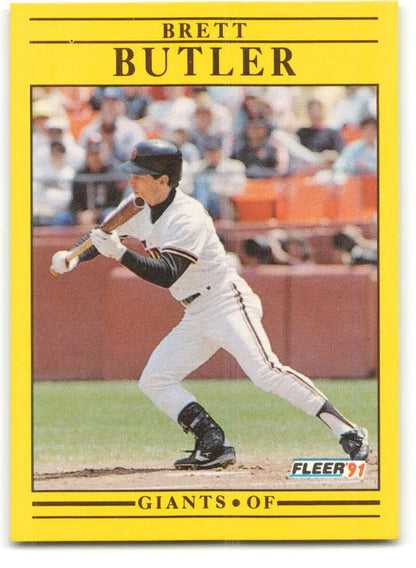 Yellow-bordered baseball card of Brett Butler, San Francisco Giants outfielder bunting